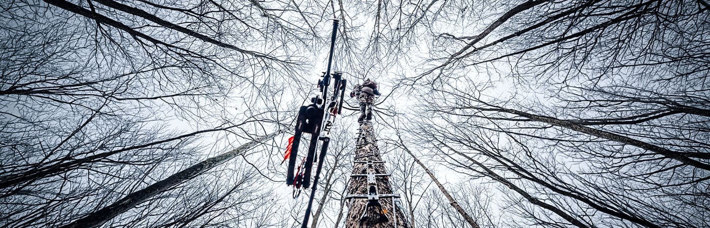 Hunter packing a Hawk treestand into the timber
